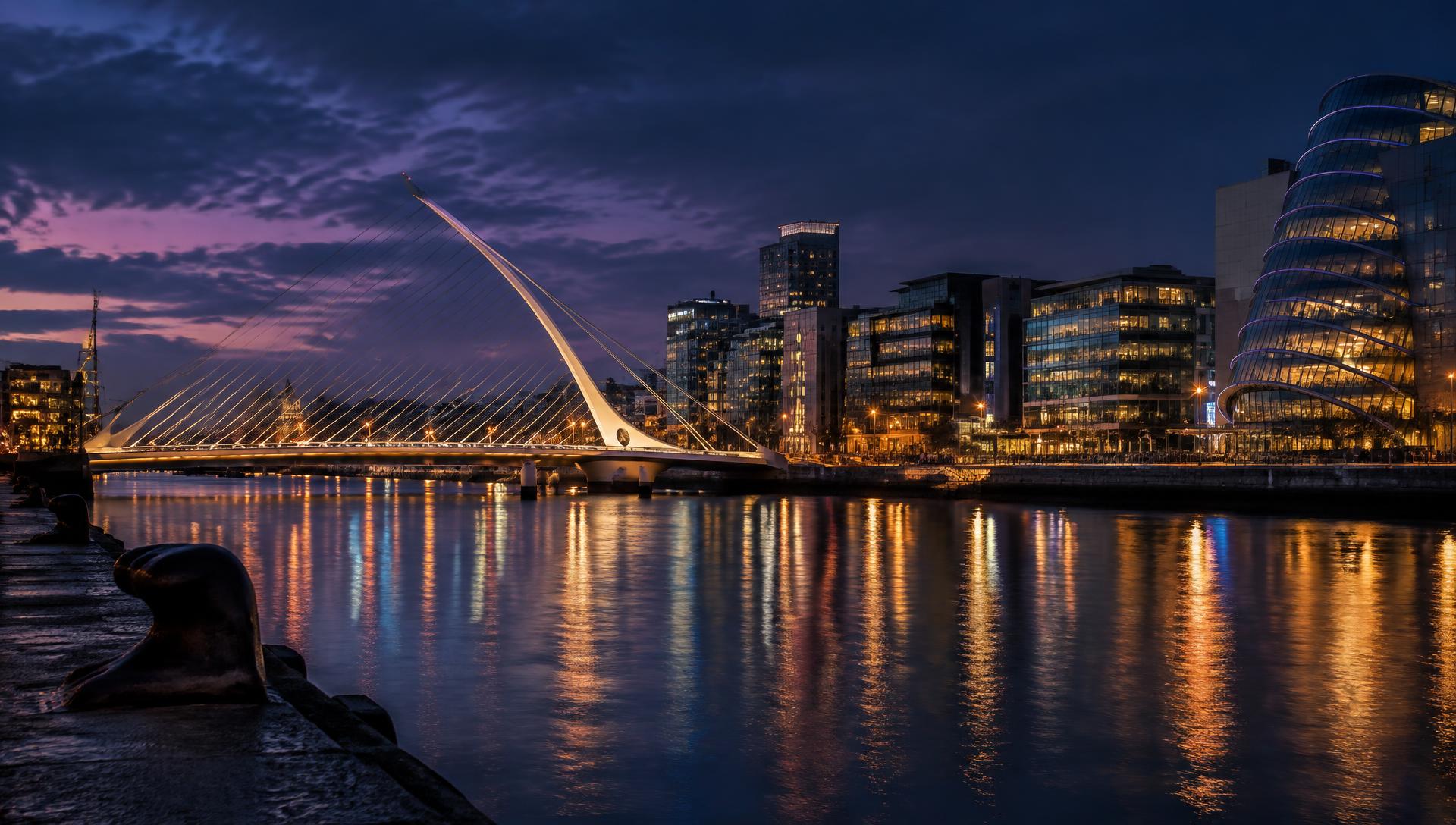 Dublin docklands and the Samuel Beckett Bridge lit at dusk